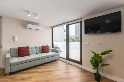 a living room with a couch and a flat screen tv at Aspasios Bonjardim Apartments in Porto