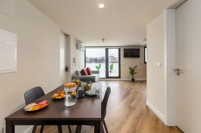 a dining room and living room with a table and chairs at Aspasios Bonjardim Apartments in Porto