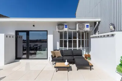 a living room with a couch on a patio at Aspasios Bonjardim Apartments in Porto