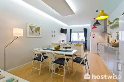 a kitchen and dining room with a table and chairs at Host Wise - Comfortable Stunning Flats - City Center in Porto