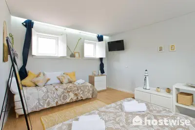 a room with a bed and a couch in it at Host Wise - Comfortable Stunning Flats - City Center in Porto