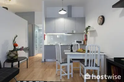 a kitchen and living room with a table and chairs at Host Wise - Comfortable Stunning Flats - City Center in Porto