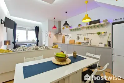 a kitchen with a table with a bowl of bananas on it at Host Wise - Comfortable Stunning Flats - City Center in Porto