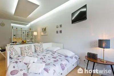 a bedroom with a white bed and a table at Host Wise - Comfortable Stunning Flats - City Center in Porto