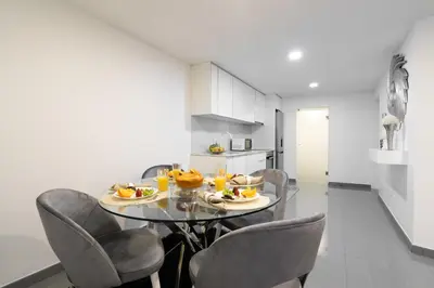 a dining room with a table and chairs at Host Wise - Spacious Noble Apartaments Ace Location in Porto