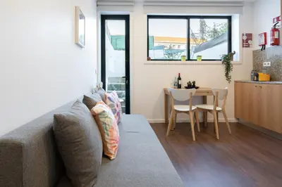 a living room with a couch and a table at Host Wise - Modern Studios with Terrace - Walk Everywhere in Porto