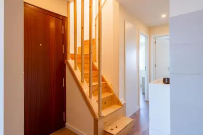 a staircase in a house with a wooden door at Host Wise - Fantastic Contemporary Flat w Balcony in Porto
