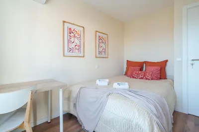 a small bedroom with a bed and a desk at Host Wise - Fantastic Contemporary Flat w Balcony in Porto