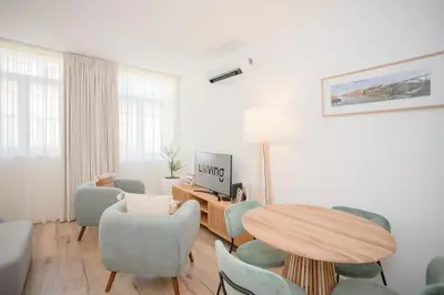 a living room with a table and chairs at Liiiving in Porto - Urban Art Apartment in Porto