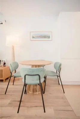 a dining room table with four chairs and a table at Liiiving in Porto - Urban Art Apartment in Porto