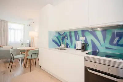 a living room with two chairs and a television at Liiiving in Porto - Urban Art Apartment in Porto