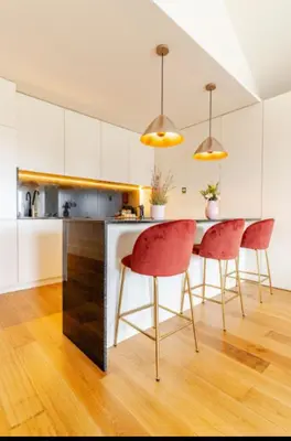 a kitchen with red chairs and a kitchen island at Fontainhas Hidden Gem in Porto