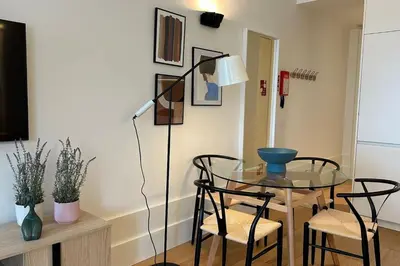 a glass table with chairs and a lamp in a room at Fontainhas Hidden Gem in Porto