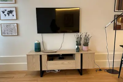 a living room with a television on a tv stand at Fontainhas Hidden Gem in Porto