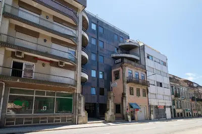 an empty city street with a building with a spiral at Dennis Family Friendly House by RDC in Porto