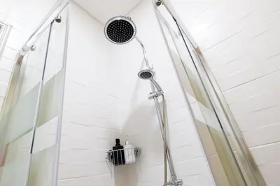 a shower with a shower head in a bathroom at Dennis Family Friendly House by RDC in Porto