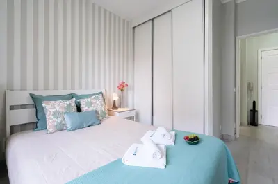 a bedroom with a large bed with towels on it at Host Wise - Modern Flats with Stunning Terrace or Balcony - Central Location in Porto