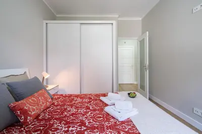 a bedroom with a bed with towels on it at Host Wise - Modern Flats with Stunning Terrace or Balcony - Central Location in Porto
