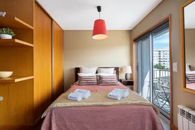 a bedroom with a bed with two towels on it at Host Wise - Bright Fresh Flat with Garage - Marquês in Porto