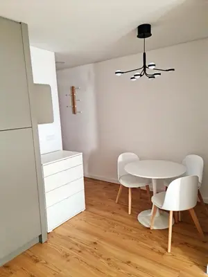 a dining room with a white table and chairs at Campanhã Studio in Porto