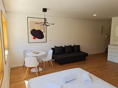 a living room with a couch and a table at Campanhã Studio in Porto