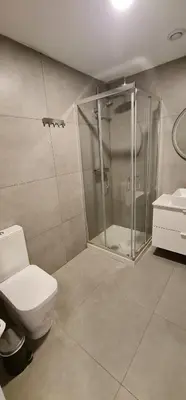 a bathroom with a shower and a toilet and a sink at Campanhã Studio in Porto