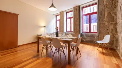 a dining room with a table and white chairs at Bento Living by LovelyStay in Porto