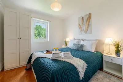 a bedroom with a bed with a blue blanket at Host Wise - Classy Amazing Flats in Porto
