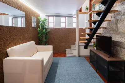 a living room with a white couch and a tv at Host Wise - Classy Amazing Flats in Porto