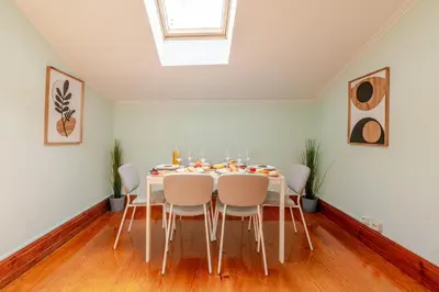 a white dining room with a table and chairs at Host Wise - Classy Amazing Flats in Porto