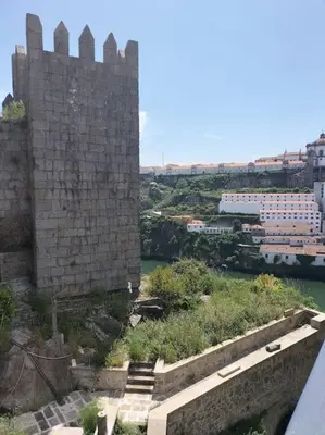a view of a castle with a river and buildings at Loft in the historic center of Oporto downtown in Porto