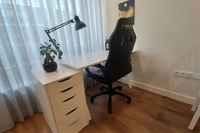 an office with a desk with a chair and a lamp at A H - Apartment Oporto Downtown in Porto