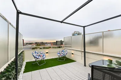 a balcony with two chairs and a table at Julio Dinis Porto Secret Retreat - by Guest SPA in Porto