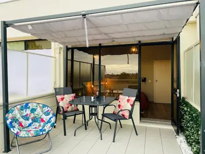 a patio with a table and chairs on a balcony at Julio Dinis Porto Secret Retreat - by Guest SPA in Porto