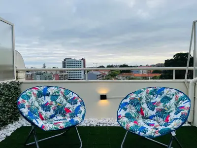 two chairs sitting on top of a balcony at Julio Dinis Porto Secret Retreat - by Guest SPA in Porto