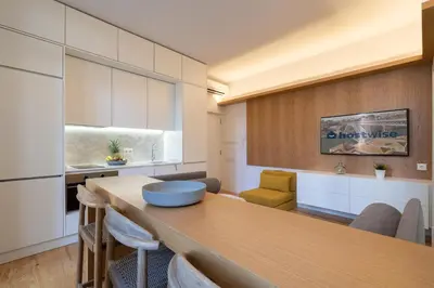 a kitchen and dining room with a table and chairs at Host Wise - Refreshing Cozy Flat - Garden & Terrace in Porto