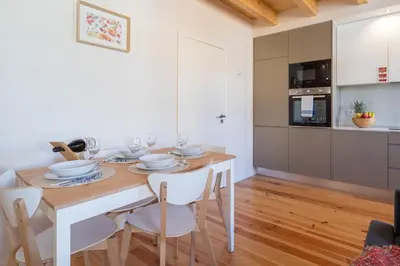 a kitchen and dining room with a table and chairs at Host Wise - Lovely & Cozy Duplex Flat in Porto