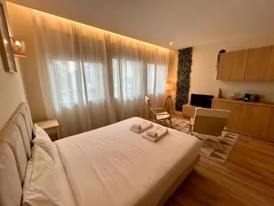a bedroom with a bed with two towels on it at Lemago Porto Apartments - Bonjardim in Porto