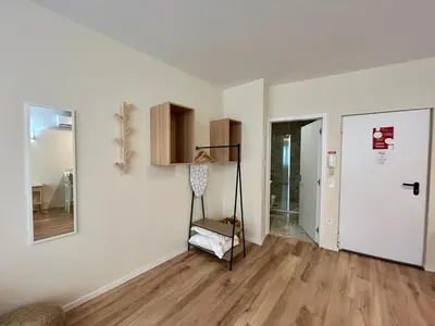 an empty living room with a wooden floor and a door at Lemago Porto Apartments - Bonjardim in Porto