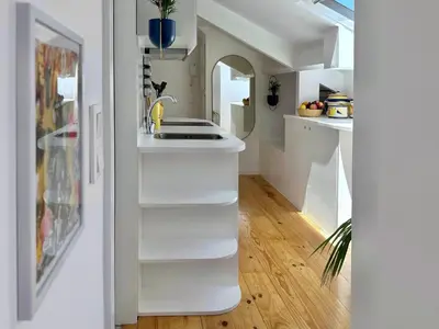 a kitchen with white shelves and a sink at Art Cottage with oPorto View! in Vila Nova de Gaia