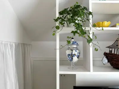 a white shelf with a blue and white vase on it at Art Cottage with oPorto View! in Vila Nova de Gaia