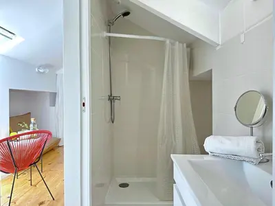 a bathroom with a shower and a sink and a mirror at Art Cottage with oPorto View! in Vila Nova de Gaia