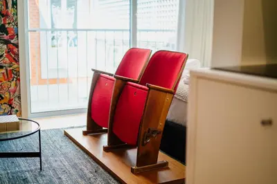 a couple of red chairs sitting in a room at Theater Studio in Porto