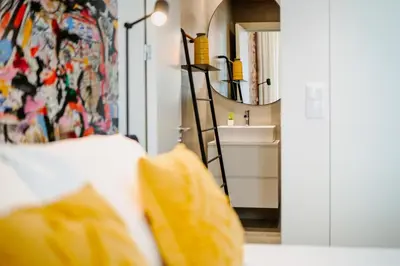a bedroom with a bed with a sink and a mirror at Theater Studio in Porto