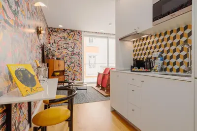 a kitchen with a counter and a table with chairs at Theater Studio in Porto