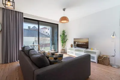 a living room with a couch and a tv at Host Wise - Charming Welcoming Flat - Centrally Located in Porto