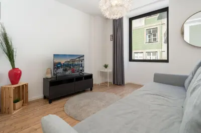 a living room with a couch and a tv at Host Wise - Charming Welcoming Flat - Centrally Located in Porto
