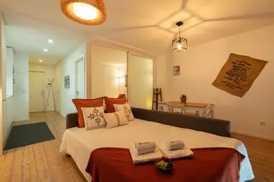 a bedroom with a large bed with two towels on it at Host Wise - Charming Welcoming Flat - Centrally Located in Porto