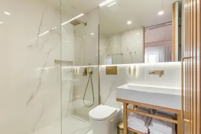 a bathroom with a shower and a toilet and a sink at Ribeira Douro Hotel in Porto