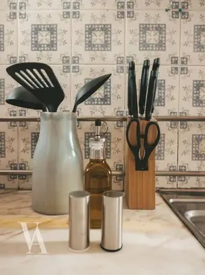 a kitchen counter with a bottle of oil and utensils at Voga Apartments Marquês in Porto